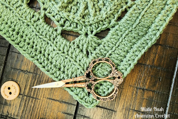 A partially completed Faithful Square on a crochet hook, showing the textured stitches in progress.