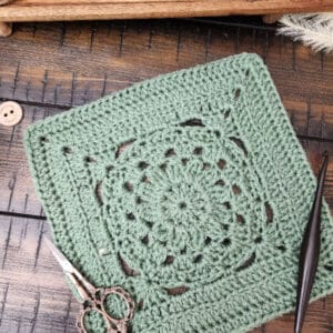 Enclave Square crochet pattern – a 9-inch textured square worked in single, half double, and double crochet stitches with clusters and back loop rows. Part of the Riverwood Square CAL 2025 hosted by American Crochet