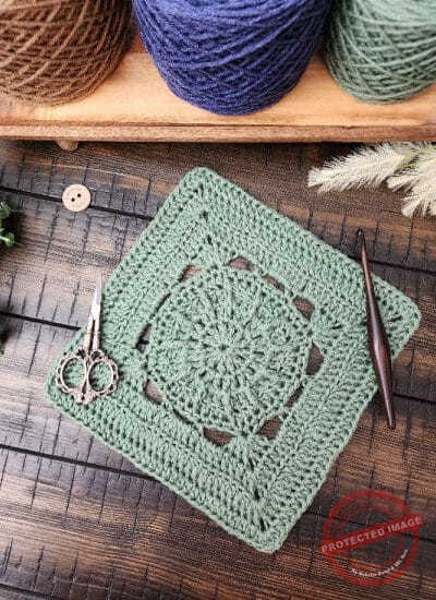 Stade Crossing Square crochet pattern – a 9-inch textured crochet square featuring single, half double, double, treble crochet stitches, with back loop and front post techniques. Part of the Riverwood Square CAL 2025
